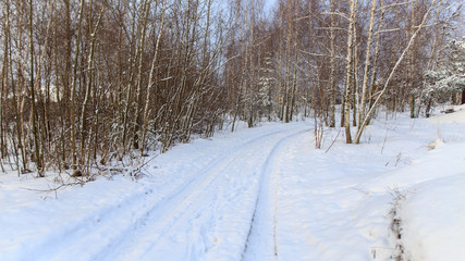 Road in the snow at sunset in winter