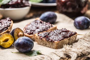 Breakfast from homemade plum jam bread and ripe plums.
