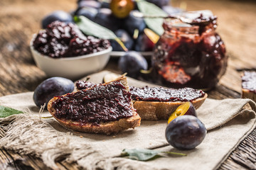 Breakfast from homemade plum jam bread and ripe plums.