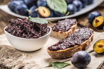 Breakfast from homemade plum jam bread and ripe plums.