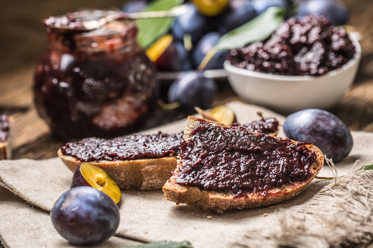 Breakfast from homemade plum jam bread and ripe plums.