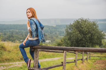 Fall, nature and people concept - Young beautiful woman with red hair have a rest in autumn time. Pretty nice woman traveler is relax. Enjoying mountains, concept adventure active vacations outdoor 