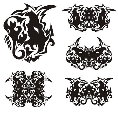 Abstract horned dragon head and butterflies formed from it. Scary ethnic dragon head in the form of a butterfly wing and the wings of butterflies created from her. Black on white