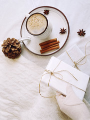 coffee with milk, cinnamon, anise, light background