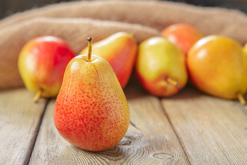 Ripe pears on rustic wooden table