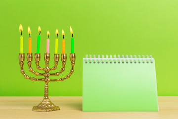 Bronze Hanukkah menorah with burning candles