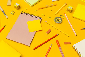 school supplies at colorful paper background