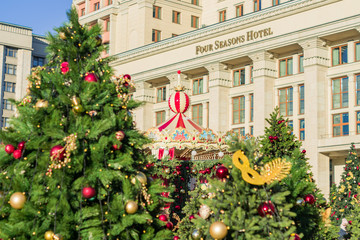 Fototapeta na wymiar City christmas decoration. Christmass trees in front of the Four season hotel