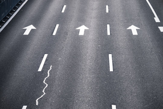 Asphalt road with arrow sign