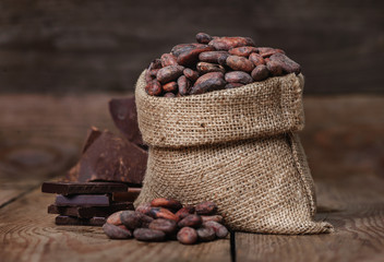 Raw unpeeled cacao beans and chocolate