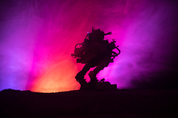 Silhouette of Giant robot. Futuristic tank in action with foggy fire sky background