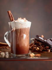 Cocoa with cream, cinnamon, chocolate pieces and various spices.