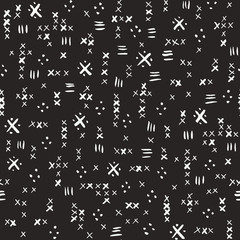 Hand drawn white tribal marks, cross stitches on dark background vector seamless pattern. Abstract geometric print