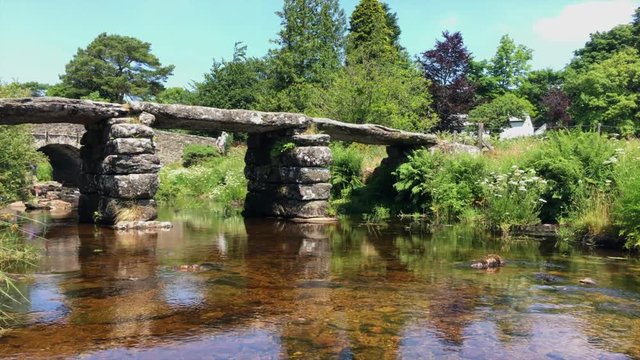 Pan from right to left of clapper bridge at Postbridge in Dartmoor, UK