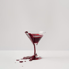 Martini glass full of blood. Minimal horror concept.