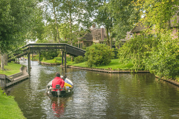 Tourist with a rented boat floating in Giethoorn