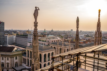 Rooftop view of spires, sculpture, cathederal, and Milan from the Duomo di Milan