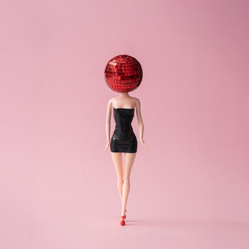 Girl in black dress with red disco ball head. Minimal party concept.