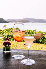 Summer refreshing cold cocktial in tall glass with sea background