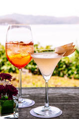 Summer refreshing cold cocktial in tall glass with sea background