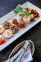 Asian canapes appetizer - Smoked salmon, maki, larb, tuna tartare spring roll and grilled shrimps