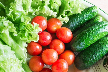 The concept of healthy eating. Background with vegetables. Green salad and tomatoes