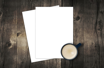 Blank letterhead and coffee cup on vintage wooden table background