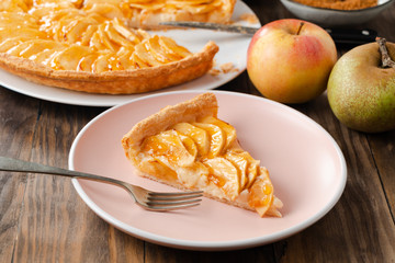 Portion of homemade apple pie tart on a pink dish