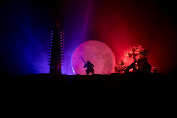 Samurai fighting concept. Silhouette of samurais in duel near tree and old temple. Picture with two...