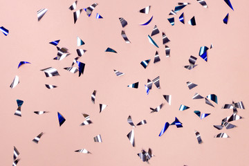 Party sparkle papers on pastel pink background