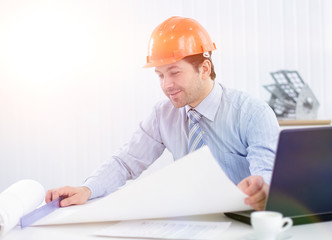 Architect looking working in office at desk.