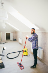 Young bearded man makes cleaning the house