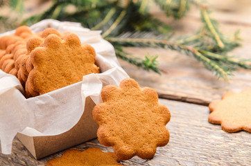 Sweet thin ginger biscuit in gift box on a wooden background. Festive pastry.