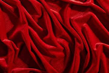 Red color velvet textiles for background or texture, wrinkled and shadows