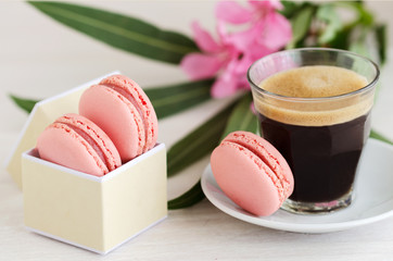 Black coffee espresso and pink macarons dessert. Good Morning concept.