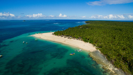 dako island pacific ocean palm trees sandy beach canoes surf drone aerial photography