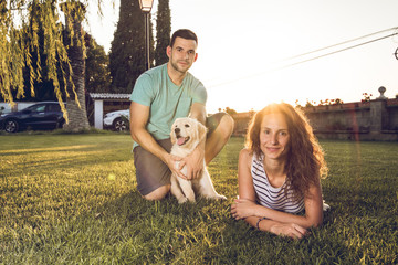 Couple in a sunset with puppy dog