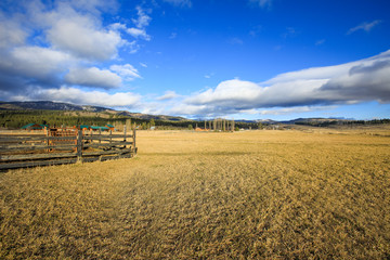 Fenced farm field with picturesque landscape.
