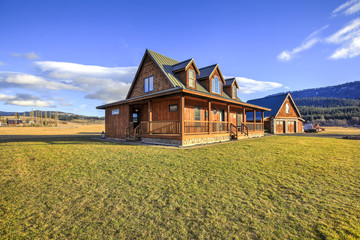 Nice wooden ranch home with beautiful landscape in the countryside. - obrazy, fototapety, plakaty