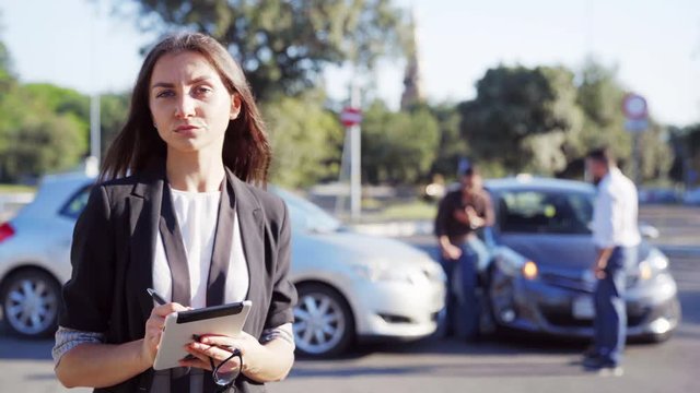 Insurance agent and the people which inspecting car accident standing on the road near damaged cars. Insurance concept. 4K UHD.
