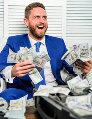 Man cheerful happy businessman with pile dollar banknotes. Profit and richness concept. Businessman...