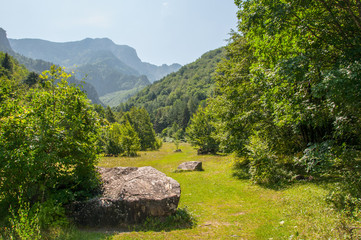 A glade among the mountains with large stones on it © drutska