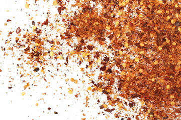 Fototapeta premium Crushed red cayenne pepper, dried chili flakes and seeds pile isolated on white background, top view