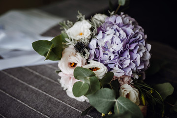 Wedding bouquet with white and purple flowers. Boho style