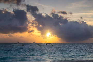 Naklejka premium Boats on a Calm Sea at Beautiful Sunset