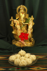 Ganesh and modak, a typical maharashtrian sweet, Pune, Maharashtra, India.