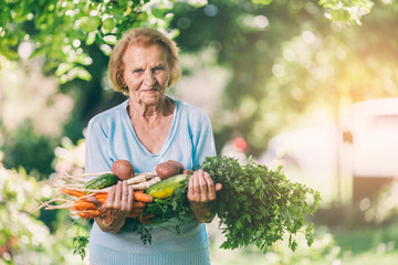 Senior woman with fresh crop from her garden
