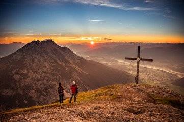 a couple enjoy the Sunset from the Mountain Stoderzinken in Austria