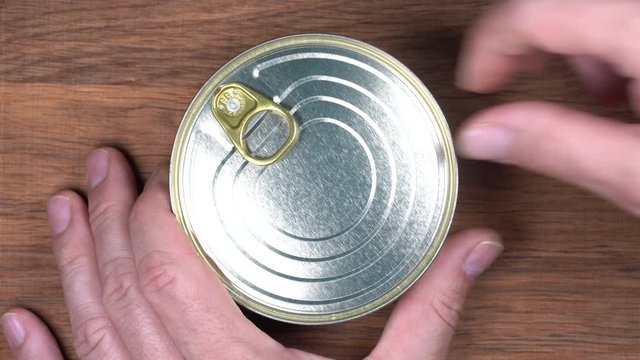 Opened tin can of sprats fish, sardines in tomato sauce. Top view, close up, macro