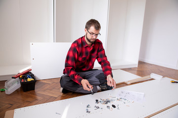 Frustrated man reading instruction
